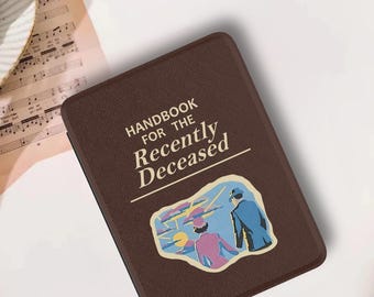 May include: A dark brown rectangular e-reader case with a textured surface. The cover features the white text "HANDBOOK FOR THE Recently Deceased" above a colorful illustration of two figures standing before a landscape with a yellow sun.