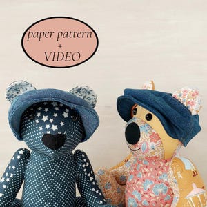 May include: Two handmade teddy bears wearing denim caps. One bear is navy blue with white stars and polka dots, the other is patterned with floral and geometric designs. The image includes text that says "paper pattern + VIDEO".