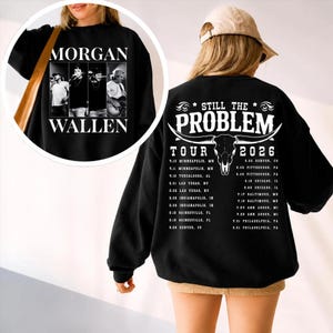 May include: Black sweatshirt featuring a graphic of Morgan Wallen with the text "MORGAN WALLEN" on the front. The back displays "STILL THE PROBLEM TOUR 2026" with a bull skull graphic and tour dates.