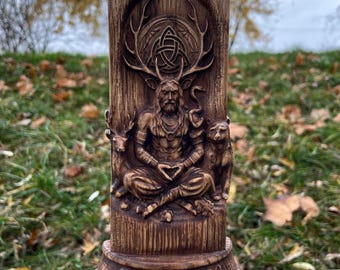 Könnte beinhalten: Eine geschnitzte Holzstatue von Cernunnos, dem gehörnten Gott, in sitzender Pose. Die Statue weist aufwendige Details auf, darunter ein Geweih, einen Bart und eine herzförmige Handgeste. Ein Bär und ein Hirsch befinden sich auf beiden Seiten der Figur. Die Basis der Statue ist mit dem Namen "CERNUNNOS" beschriftet.