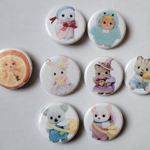 May include: A collection of eight round pinback buttons featuring various adorable animal characters in costumes. The buttons showcase a variety of colors, including pastels and bright hues, with detailed illustrations of each character.