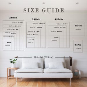 May include: A wall art size guide displays various rectangular dimensions in inches and centimeters, including 2:3, 3:4, and 4:5 ratios, and 11x14 and 5x7 inch sizes. The text "SIZE GUIDE" is at the top. A white sofa is below.
