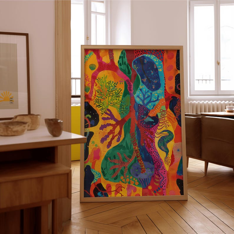 May include: A large, framed abstract painting with a vibrant colour palette. The artwork features a mix of organic shapes and patterns in shades of yellow, red, green, blue, and orange. The wooden frame complements the artwork's bold colours.