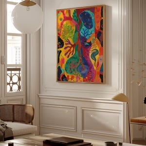 May include: A framed abstract painting with a vibrant mix of colours, including yellow, red, blue, and green. The artwork features organic shapes and patterns, creating a dynamic composition. The frame is gold.