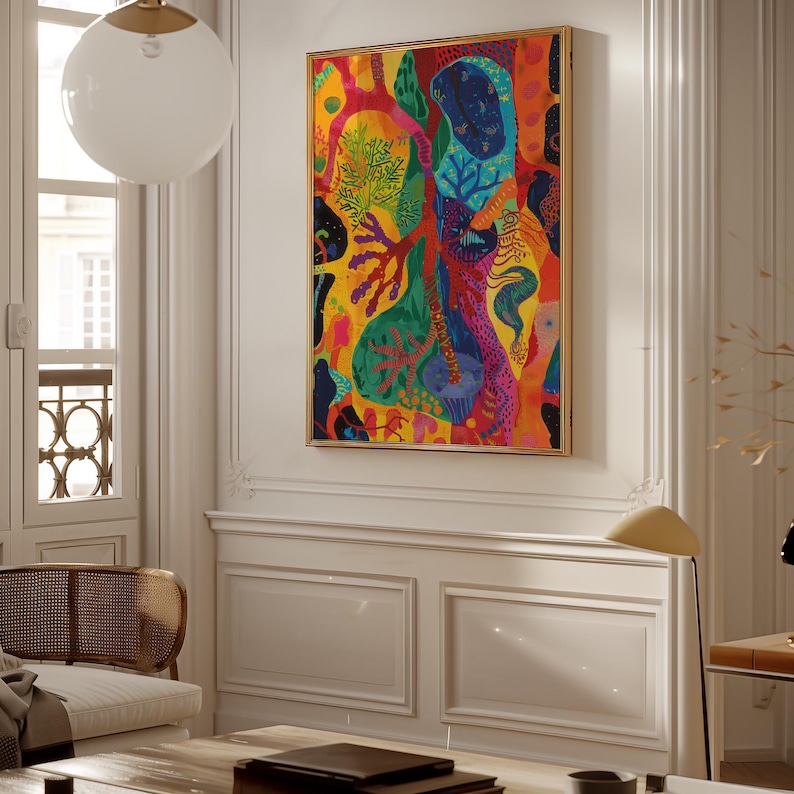 May include: A framed abstract painting with a vibrant mix of colours, including yellow, red, blue, and green. The artwork features organic shapes and patterns, creating a dynamic composition. The frame is gold.