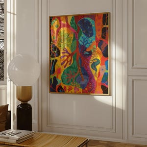 May include: Abstract art print in a gold frame. The artwork features a vibrant mix of colours, including yellow, red, green, and blue. The design includes organic shapes and patterns, creating a visually dynamic composition. The artwork is displayed on a white wall.