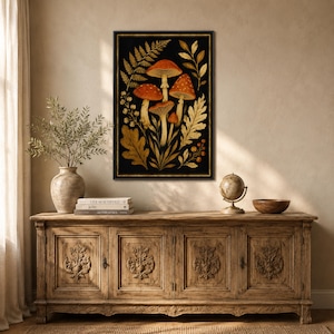 May include: A rectangular framed wall art print featuring a botanical illustration on a black background. The artwork displays several orange-capped mushrooms surrounded by golden-brown fern leaves, oak leaves, and small berry sprigs in a vertical arrangement.