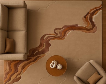 May include: A beige area rug with a flowing, abstract design in shades of brown and tan. The rug features a wavy pattern and is surrounded by a sofa, armchair, and a round coffee table. The coffee table has two white decorative objects and a cup.