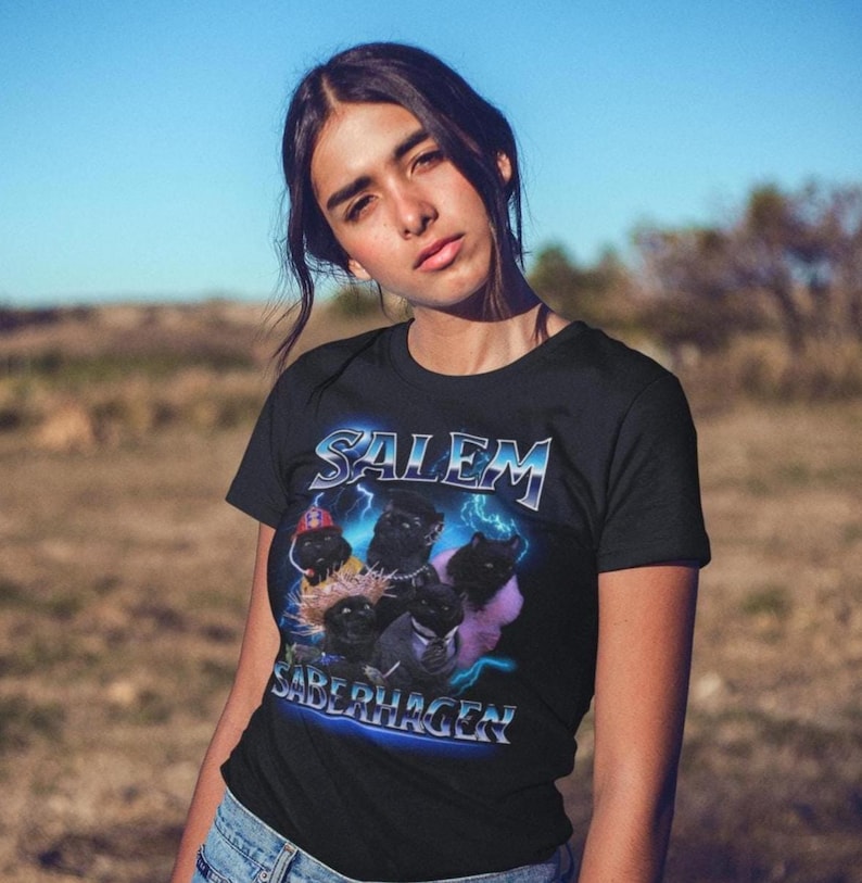 Unleash your dark humor and nostalgia with our Salem Saberhagen Shirt, a perfect tribute to the beloved 90s TV sitcom Sabrina the Teenage Witch. Featuring everyone's favorite sarcastic, spell-casting feline, this Salem tee is a must-have for fans of 90s nostalgia, witchy vibes, and sassy talking cats. Whether you're reminiscing about the y2k era, looking for a fun Halloween costume, or adding some witchy humor to your everyday wardrobe, this shirt has you covered!
