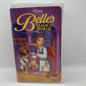 May include: A VHS tape for Disney's "Belle's Magical World." The cover features Belle, the Beast, and other characters in a colorful illustration. The title is in yellow script, with the Disney logo at the top. The bottom reads "3 Magical Storybook Adventures."