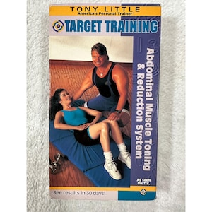 May include: A VHS tape for "Target Training" by Tony Little. The cover features a man and woman in workout attire. Text includes "Abdominal Muscle Toning & Reduction System" and "See results in 30 days!"