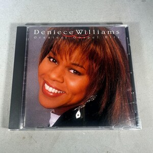 Peut inclure: Un boîtier de CD présentant l'album Greatest Gospel Hits de Deniece Williams. La couverture montre une femme souriante aux cheveux bruns et une veste noire. Le titre de l'album est imprimé en blanc et rouge.