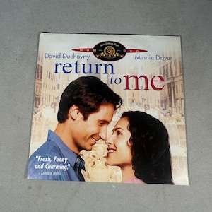 May include: DVD of the movie "Return to Me" featuring David Duchovny and Minnie Driver. The cover art shows the actors close together, with the title in large letters. The DVD case has a quote from Leonard Maltin.