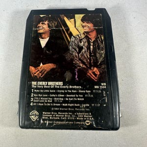 May include: A vintage black 8-track tape of The Everly Brothers' album, "The Very Best Of The Everly Brothers." The cover features a color photo of the duo. The tracklist includes "Wake Up Little Susie" and "Bye Bye Love."