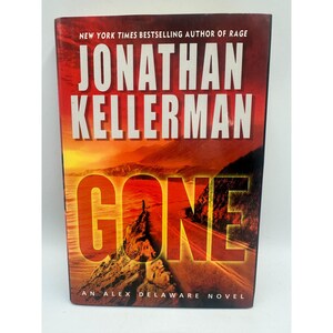 May include: A hardcover book titled "GONE" by Jonathan Kellerman. The cover features a scenic landscape with a road, a figure, and the title in large, bold letters. The author's name is prominently displayed at the top.