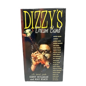 May include: A VHS tape for "Dizzy's Dream Band" featuring a photo of a man playing a trumpet. The title is in yellow, with a list of names on the right side. The text "with special guests Gerry Mulligan and Max Roach" is at the bottom.