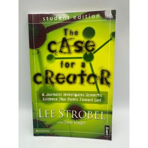 May include: A book titled "The Case for a Creator" with a green and yellow cover. The cover features the title in large, bold letters, with the author's name and a subtitle. The book is a student edition.