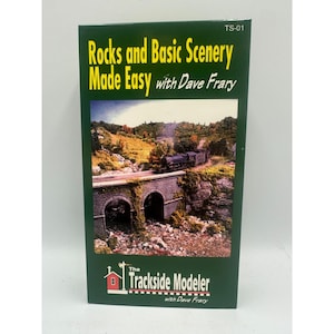 May include: A green box with the title "Rocks and Basic Scenery Made Easy with Dave Frary." The cover features a detailed model train scene with a bridge and a train. The Trackside Modeler logo is at the bottom.