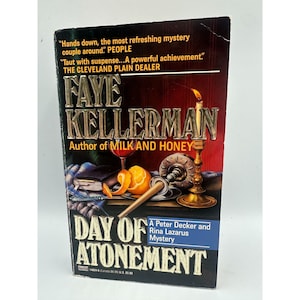 May include: A book cover for "Day of Atonement" by Faye Kellerman. The cover features the author's name in large, ornate letters. A lit candle, a glass of red wine, and an orange are also depicted. The book is part of the Peter Decker and Rina Lazarus Mystery series.