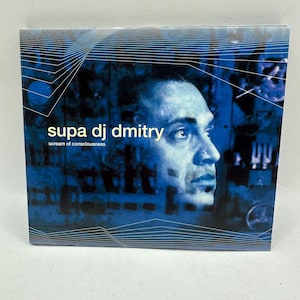 May include: A square music CD case featuring a blue-toned graphic design. The cover displays a portrait of a person in profile, overlaid with the text "supa dj dmitry" and "scream of consciousness" in white and yellow lettering against a dark background.