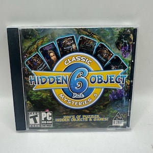 May include: A PC DVD-ROM game case titled Classic 6 Hidden Object Mysteries 5. The cover features a large blue number 6 in a yellow circle, surrounded by six smaller game box art images, a forest background, and the text 1000's of Puzzles, Hidden Objects & Games!
