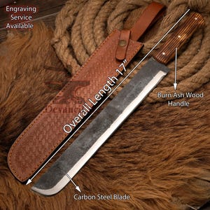 May include: A 17-inch long carbon steel blade with a burn ash wood handle. The blade is sharp and has a slight curve. The handle is brown and has a natural finish. The blade is in a brown leather sheath with a woven pattern.