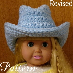 May include: A light blue crocheted cowboy hat with a brim, worn by a doll with blonde hair. The hat is labeled "Easy Creations Revised Pattern".