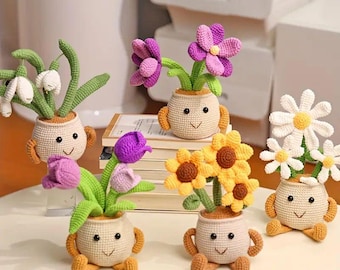 May include: Six crocheted flower pots with smiling faces. Each pot has a different type of flower, including snowdrops, tulips, daisies, and sunflowers.
