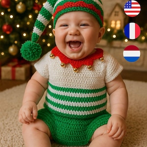 Peut inclure: Un bébé vêtu d'un costume d'elfe en crochet fait main. L'ensemble comprend un chapeau rayé vert et blanc, un haut blanc avec un col rouge, un short vert et des chaussons verts avec des nœuds rouges. Le bébé sourit.