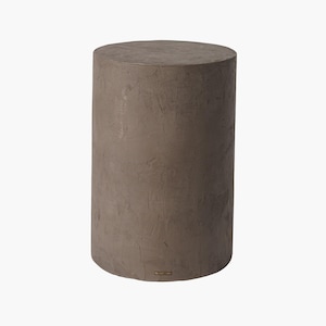 May include: A cylindrical, brown concrete side table or stool. The surface has a textured, mottled appearance. The design is simple and modern, suitable for indoor or outdoor use. The piece is a solid, sturdy structure.