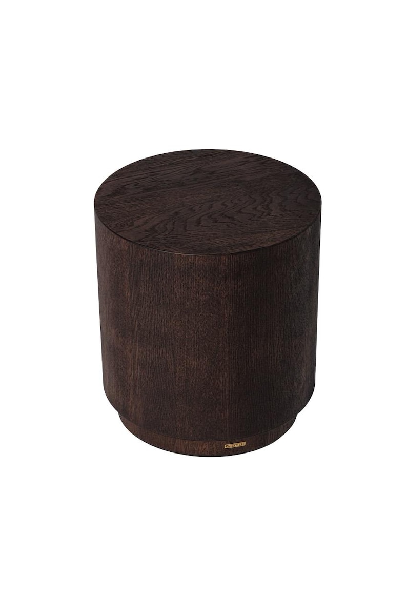 May include: A dark brown, cylindrical wooden side table. The table has a round top and a slightly wider base. The wood grain is visible, giving it a natural look. The design is simple and modern, suitable for various interior styles.
