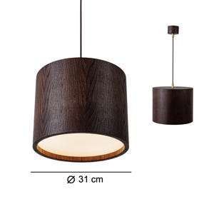 May include: A dark brown, cylindrical pendant light with a wood grain texture. The light fixture is 31 cm in diameter and hangs from a black cord. The interior of the shade is white, and the top is a lighter brown.