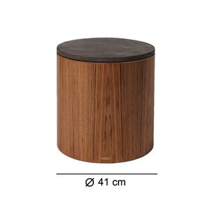 May include: A cylindrical wooden side table with a dark gray top. The table has a diameter of 16 inches. The wood grain pattern is visible on the sides of the table. The table has a modern design and is suitable for various interior settings.