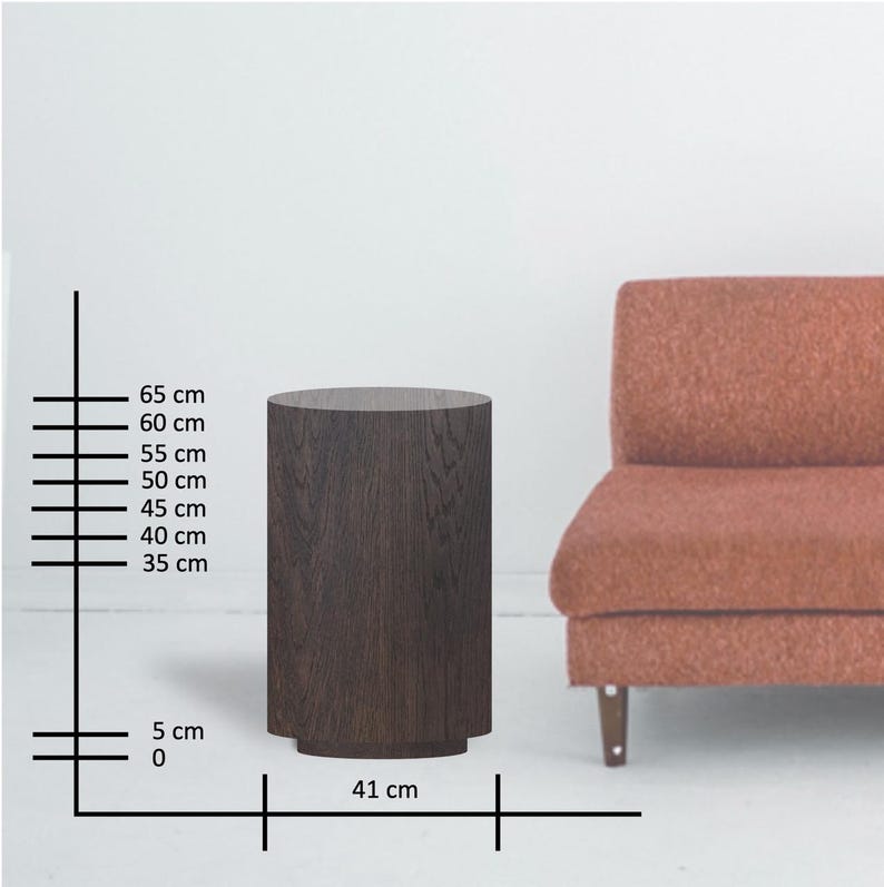 May include: A dark brown, cylindrical side table with a textured wood grain finish. The table is 25.6 inches tall and 16.1 inches wide. The table has a slightly wider base and is next to a rust-colored sofa.