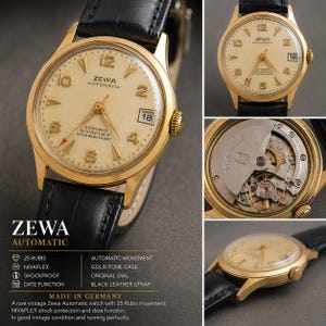 May include: A vintage Zewa Automatic watch with a gold-tone case, a cream-coloured dial featuring Arabic numerals, a date window at the three o'clock position, and a black leather strap. The watch movement is visible, showing 25 rubis markings.