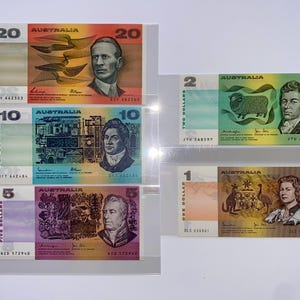 May include: A selection of Australian banknotes, including 1, 2, 5, 10, and 20 dollar denominations. The notes display portraits, illustrations, and the word "Australia". The banknotes are presented in clear protective sleeves.