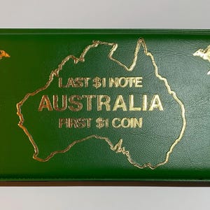 May include: Green collector's case with gold lettering and a map of Australia. The text reads "LAST $1 NOTE AUSTRALIA FIRST $1 COIN." Two gold kangaroos are on the cover.