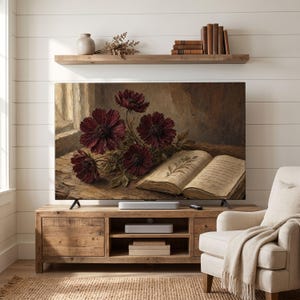 May include: A flat-screen television displaying a digital painting of dark red flowers and an open antique book with handwritten text and a botanical illustration on a wooden surface, positioned on a wooden media console with a shelf above.