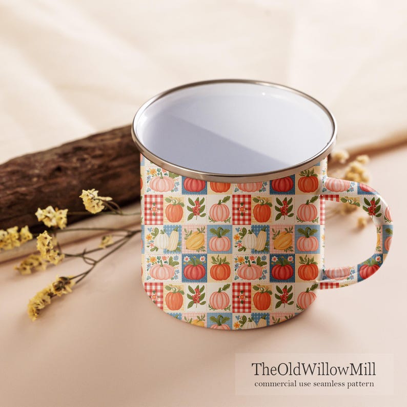 Puede incluir: Una taza de esmalte blanco con borde plateado y un patr&oacute;n de cuadr&iacute;cula repetitivo con calabazas coloridas, flores peque&ntilde;as y cuadrados a cuadros rojos y blancos. El texto TheOldWillowMill commercial use seamless pattern est&aacute; impreso.
