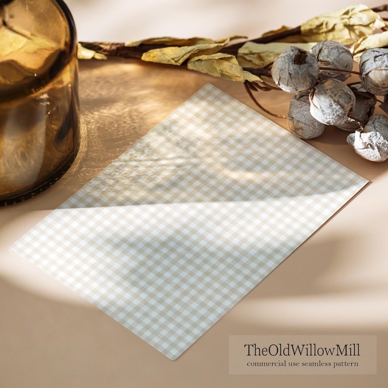 May include: A beige and white checkered pattern fabric is displayed on a light brown surface. Dried foliage and a brown glass bottle are in the background. The text "TheOldWillowMill commercial use seamless pattern" is in the lower right corner.