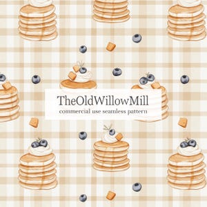 May include: A repeating watercolour pattern of pancakes with cream, blueberries, and caramel pieces on a beige and white checked background. The text "TheOldWillowMill commercial use seamless pattern" is in the center of the image.