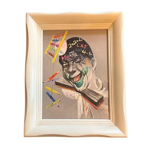 May include: Framed artwork featuring a surreal portrait with a person's face, green mouth, and math equations on the head. Colorful pencils and an abacus are also included. The frame is white.