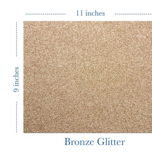 May include: A sheet of bronze glitter heat transfer vinyl measuring 11 inches by 9 inches. The vinyl is a sparkly, metallic bronze color. The text "Glam Flex" is in the upper right corner of the image.