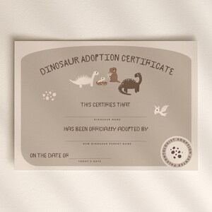May include: A tan dinosaur adoption certificate with illustrations of dinosaurs and the text "DINOSAUR ADOPTION CERTIFICATE". The certificate includes spaces to fill in the dinosaur's name, the adopter's name, and the date of adoption.