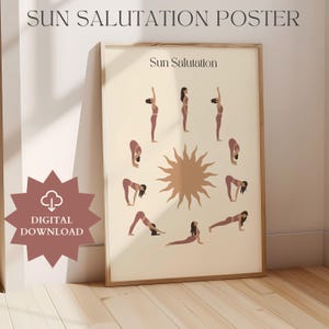 May include: A framed poster with the text "SUN SALUTATION POSTER" at the top. The poster features illustrations of yoga poses around a sun graphic. The words "Sun Salutation" are printed on the poster. A digital download icon is in the lower left corner.