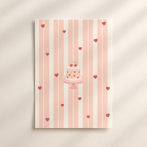 May include: A rectangular print featuring a pink and white striped background with scattered red hearts. A pink cake with heart decorations and cherries sits on a cake stand. The print has a soft, romantic aesthetic.