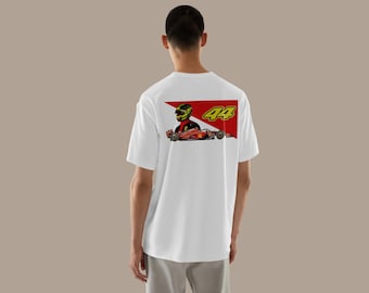 May include: White t-shirt with a graphic of a racing car and driver, displaying the number 44. The design incorporates red and yellow colours. The person is wearing a white t-shirt.