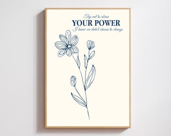 May include: A framed art print with a cream background. The print features a dark blue floral illustration and text that reads "Try not to abuse YOUR POWER I know we didn't choose to change."