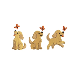 May include: Three embroidered golden retriever puppies with orange butterflies. The puppies are in different poses: sitting, looking up, and running. The butterflies are above each puppy's head.