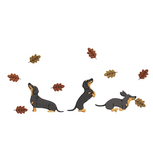 May include: An embroidered design featuring three dachshunds in various poses, with autumn leaves scattered around. The dogs are black and tan, with one standing on its hind legs. The leaves are shades of brown and gold.